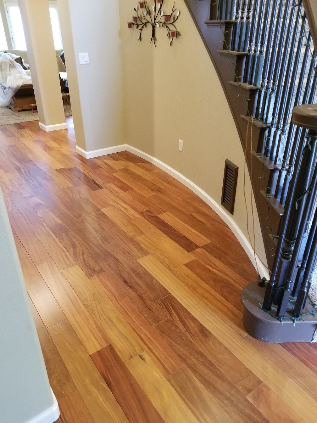 Hardwood floor hallway with curved staircase