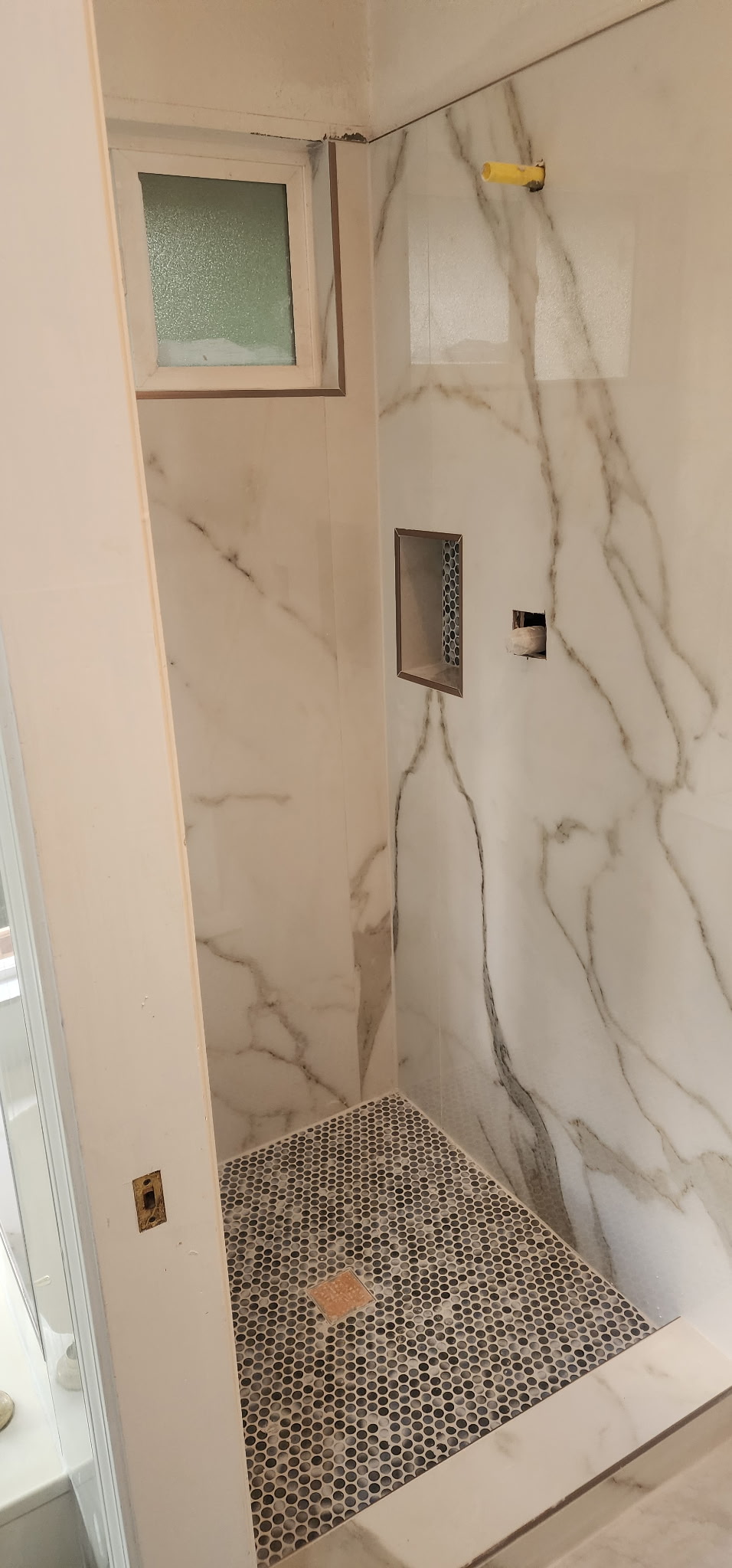 Calacatta marble slab shower with skylight