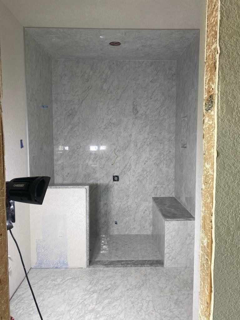 Marble shower with hexagon ceiling tile
